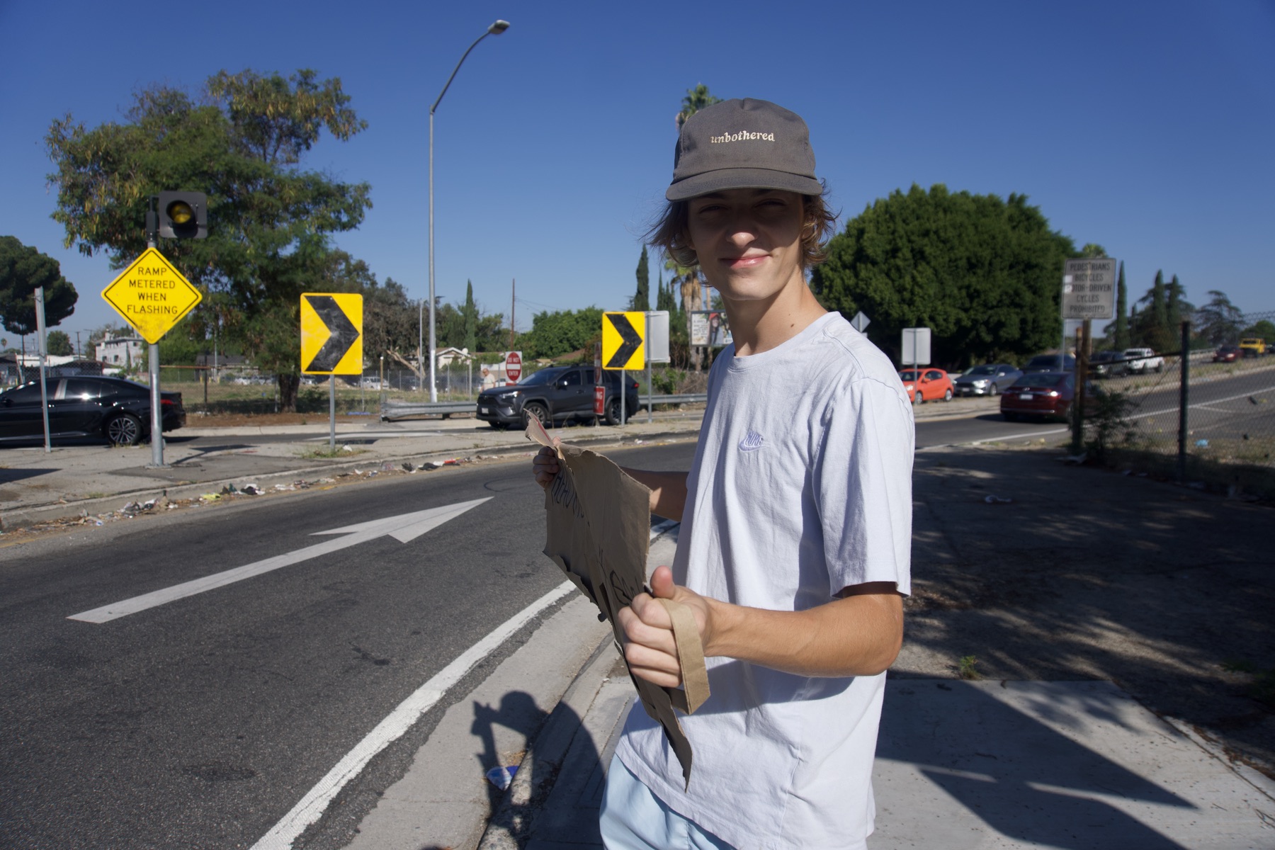 Sign in hand at the on-ramp, ready to catch our first ride